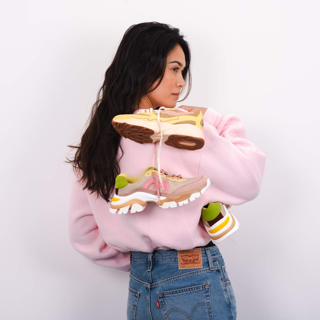 woman holding sneakers